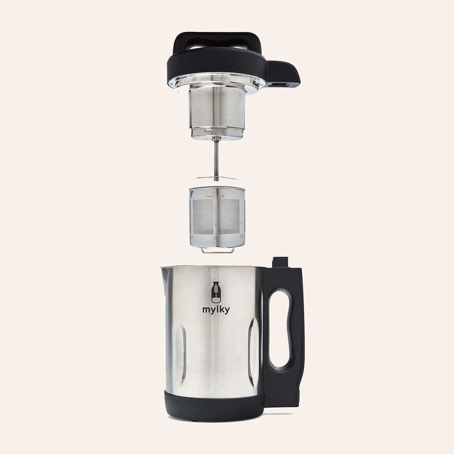 Disassembled Mylky milk maker showing the removable stainless steel filter and jug