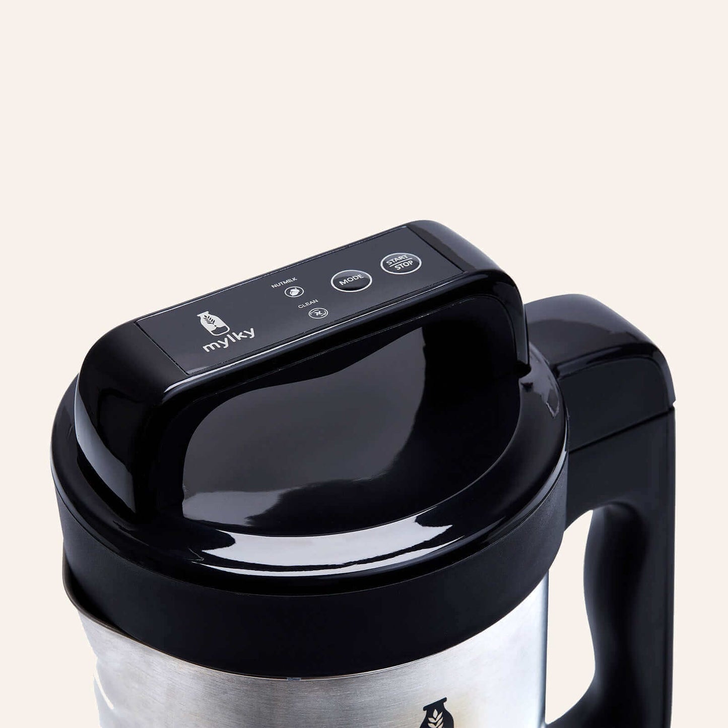 Close-up of Mylky plant-based milk maker with a sleek black lid and stainless steel body